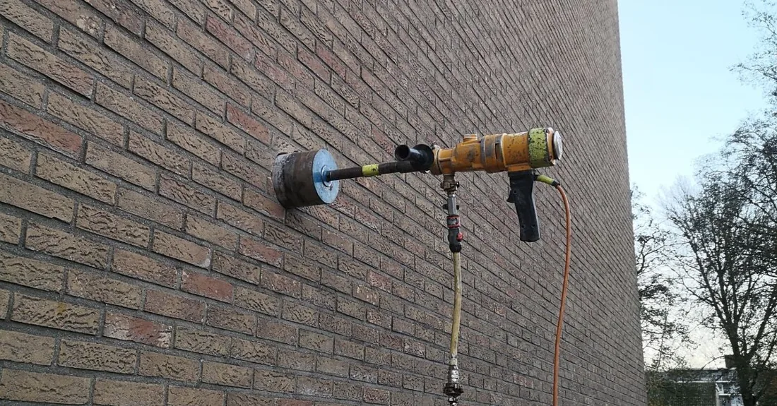 Boorwerk voor een muurdoorvoer om lucht naar buiten af te voeren.
